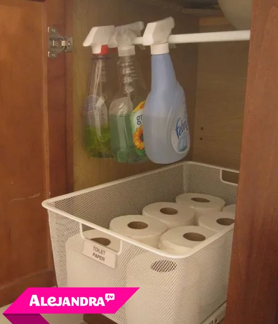 Small Bathroom Storage Ideas - just getting the spray bottles up on to a tension rod frees up space in the cabinet for a wire basket of toilet paper.