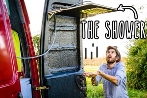 Small RV Trailers Bathroom - A shower with a rain shower head built into the rear door of a van. How awesome is that?!