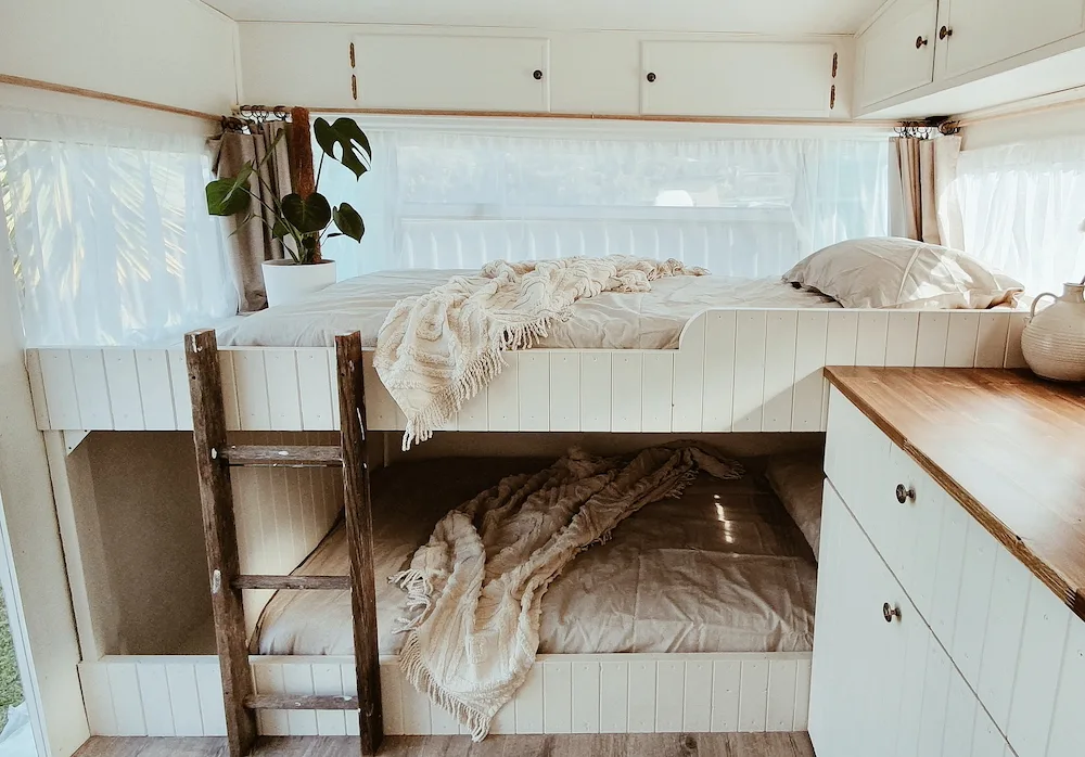 Bunk beds inside a remodeled travel trailer.
