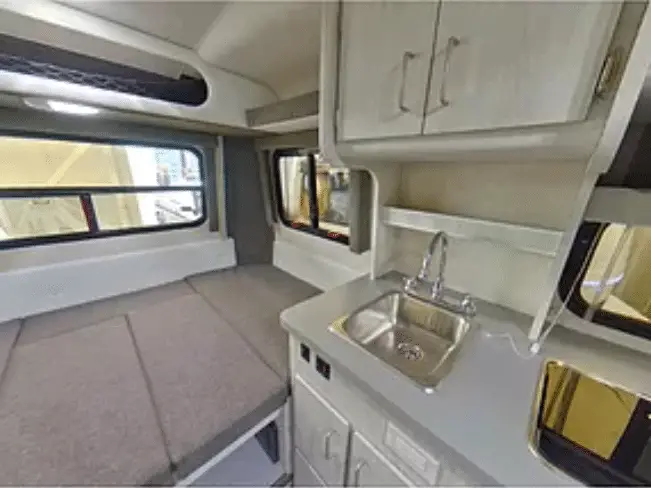 Light colored interior of a small fiberglass travel trailer