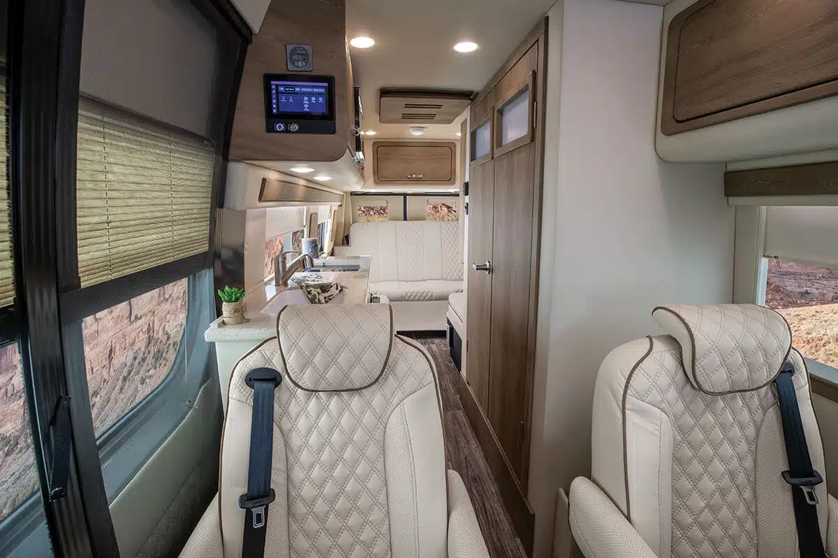 Interior a 2022 American Coach Patriot campervan looking from the front cab towards the rear.