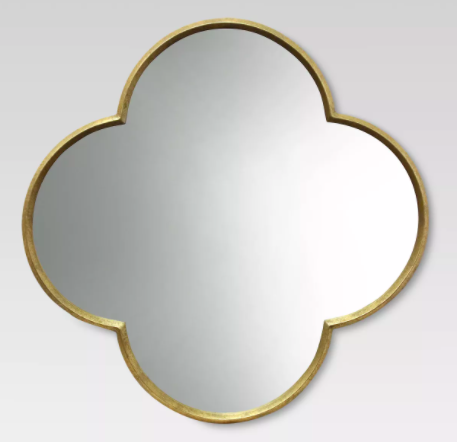Cross shaped mirror with gold trim.