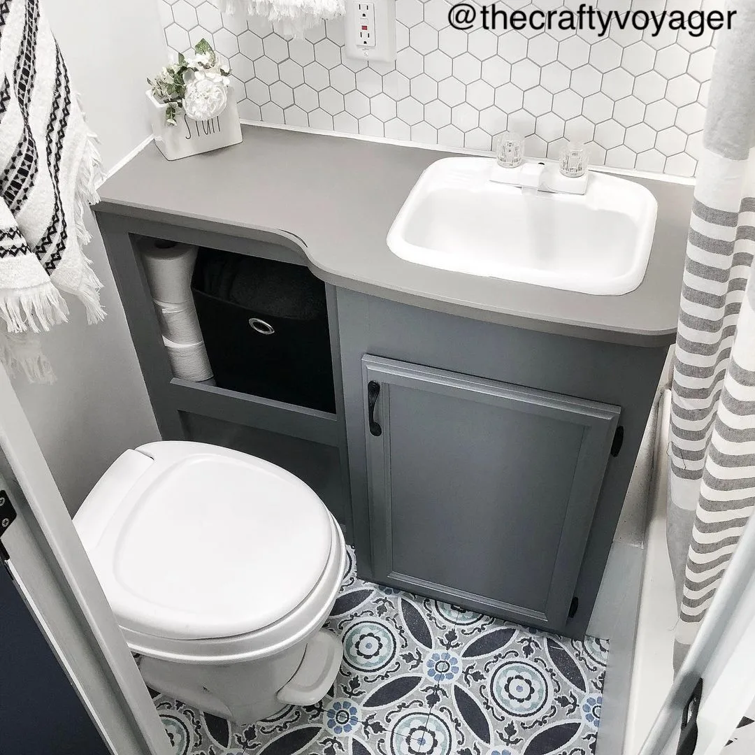 Tiny RV bathroom with grey toned decor.