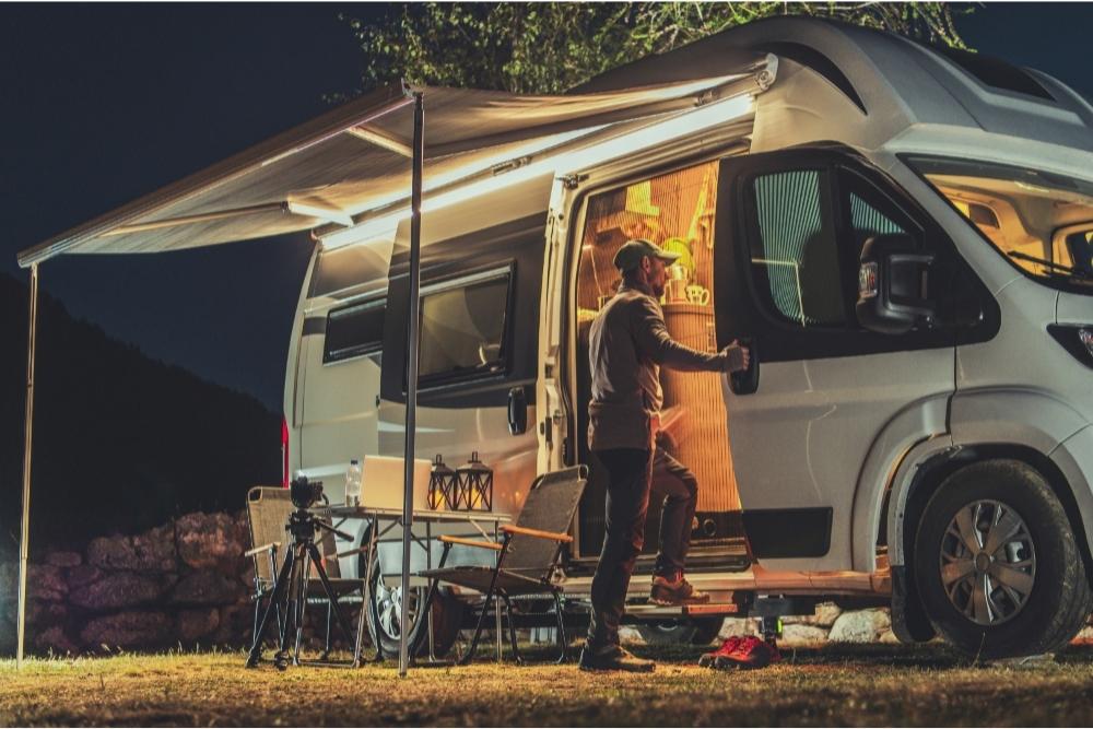 Man entering an RV in the evening.