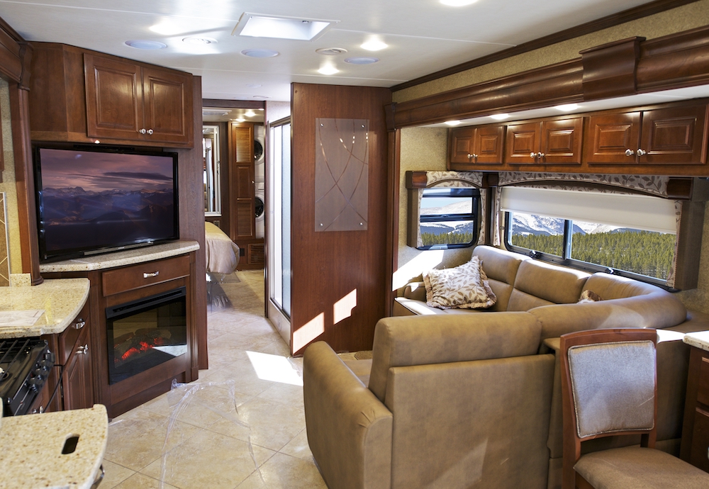 Clean, tidy and spacious interior of motorhome with brown and beige decor.