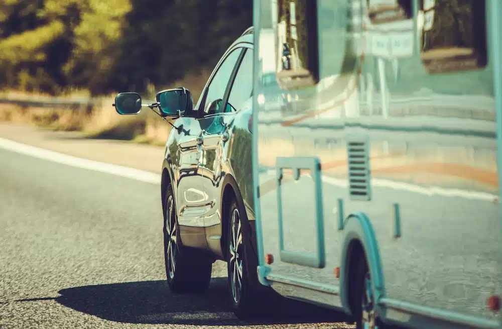 Rear view of a car towing a pull-behind camper.