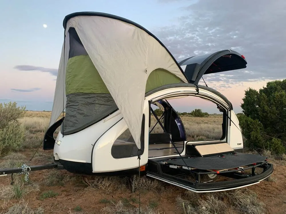 Small teardrop camper with pop-up roof and open sides