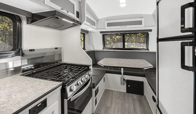 Interior view of the Escape 5.0 fifth wheel camper showing the kitchen and dining area.