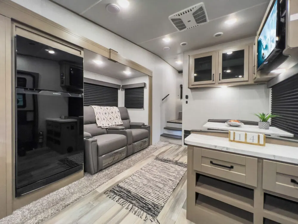 Interior of the Grand Design RV Reflection 100 Series 22RK fifth wheel camper showing the kitchen and living areas.